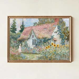 Könnte beinhalten: Gerahmtes Gemälde eines malerischen Cottages mit rotem Ziegeldach, umgeben von einem lebendigen Garten voller Sonnenblumen und anderer bunter Blumen. Eine Person in Kleid und Hut ist auf einem Weg zu sehen. Das Kunstwerk ist in einem goldenen Rahmen.