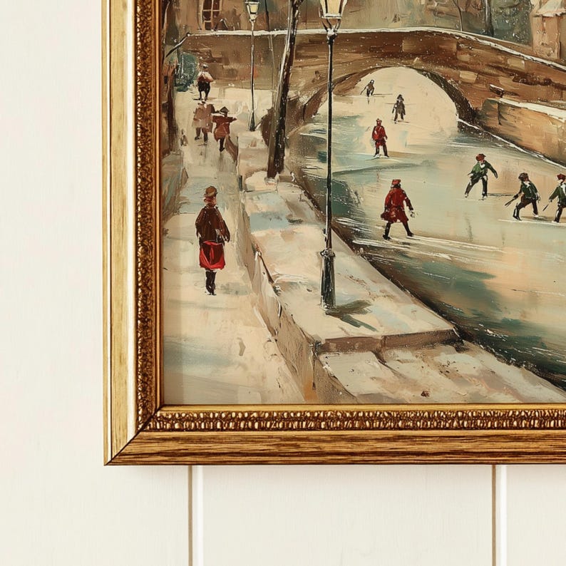 May include: A framed oil painting shows a winter scene with figures on a snowy path and bridge. The artwork features a bridge arching over a frozen waterway, with people in coats and hats. The painting has a vintage aesthetic, with a gold frame.