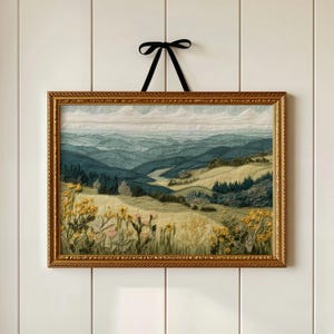 May include: A framed landscape artwork depicting rolling hills and valleys in shades of green and blue. The artwork is decorated with yellow wildflowers and a gold-coloured ornate frame. A black ribbon is used for hanging.