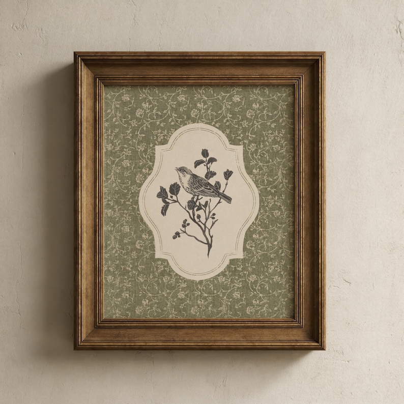 May include: A framed print featuring a detailed illustration of a bird perched on a flowering branch. The artwork is set against a patterned green background and framed in a brown wooden frame. The bird illustration is in black and white.