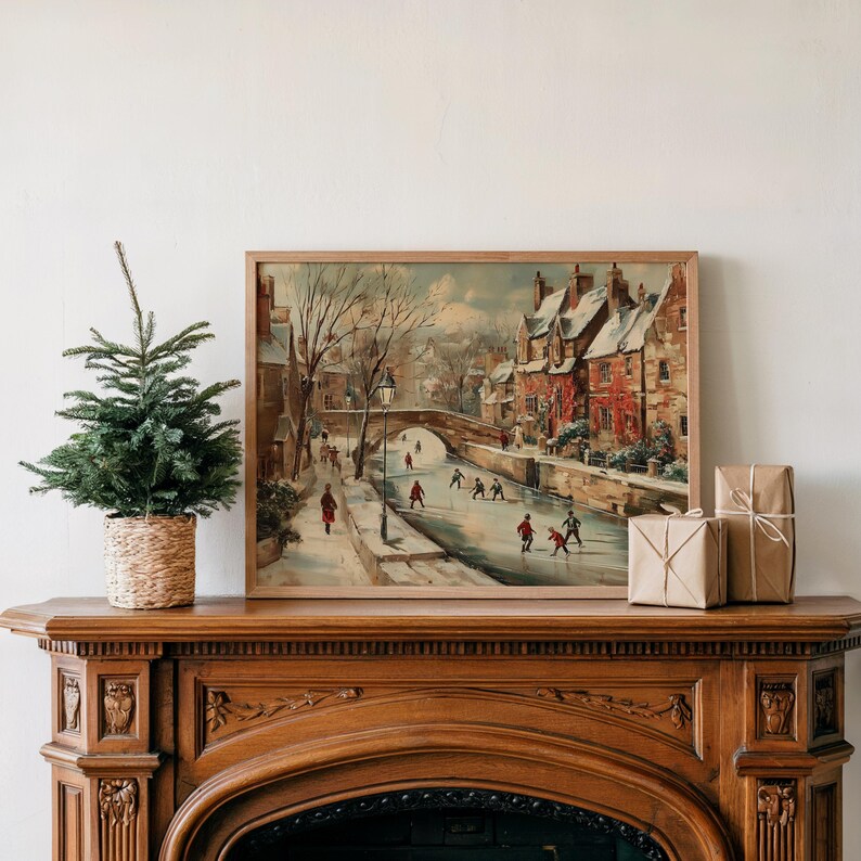 May include: A framed painting shows a winter scene with a snowy village and people ice skating on a frozen river. The artwork is displayed above a wooden fireplace mantel, with a small Christmas tree and wrapped gifts.