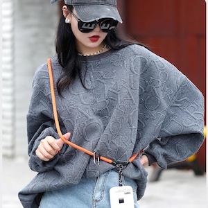 May include: An orange adjustable phone lanyard with a metal carabiner and a white phone case featuring the text "Supre 404" and "100%" printed on it. The text "ADJUSTABLE LENGTH" and "CUT FREELY TO YOUR REQUIRED LENGTH FOR A PERFECT FIT" is visible.
