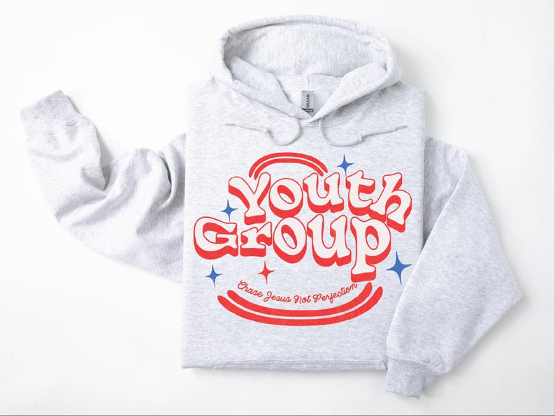 May include: Light gray hoodie with the words "Youth Group" in red and white retro font. The hoodie also has the text "Chase Jesus Not Perfection" in red. Blue star graphics are also present.