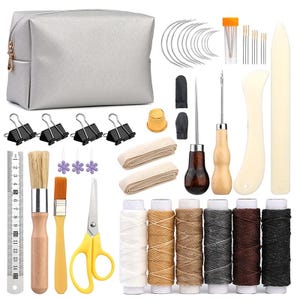 May include: A leathercrafting kit with a silver pouch, needles, thread spools, and various tools. Includes scissors, brushes, a ruler, and binder clips. The kit features a variety of colors and materials for leatherwork projects.