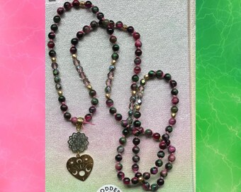 Mala de ojo de tigre verde y rosa de inspiración malvada