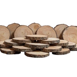May include: A collection of natural wood slices, varying in size and thickness. The slices have visible growth rings and a rough bark edge, showcasing a rustic aesthetic. Ideal for crafts or decorative purposes.