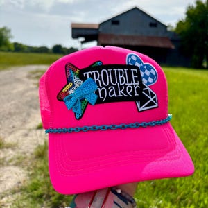 Troublemaker Trucker Hat | Hot Pink Mesh Cap with Sequin Star, Blue Chain Accent, Gingham Heart and Bow | Bold Cowgirl Statement Hat