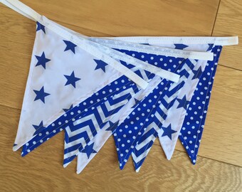 May include: A blue and white bunting with a variety of patterns, including stars, polka dots, and zigzags.