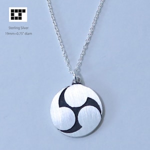 May include: Sterling silver necklace with a circular pendant. The pendant features a design of three connected circles with black accents. The pendant is 0.75 inches in diameter and hangs from a delicate chain.
