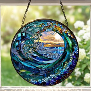May include: A circular stained glass window showing a wave design with a sunset scene. The wave is crafted from blue, green, and clear glass pieces, with a hanging chain. The sunset displays orange and yellow colours.