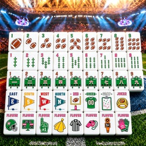 May include: A set of white mahjong tiles featuring football-themed illustrations, including brown footballs, green scoreboards with Chinese numerals, pennants labeled East, South, West, North, and various sports equipment like helmets and whistles.