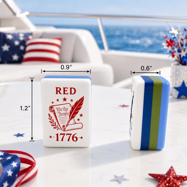 May include: A white rectangular mahjong tile featuring red text that reads RED and 1776, with an illustration of a scroll labeled We the People and a quill. The tile measures 1.2 inches in height, 0.9 inches in width, and 0.6 inches in depth.