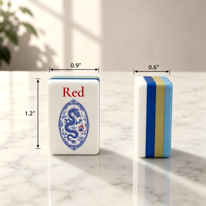 May include: Two white mahjong tiles with blue and gold side accents. The front tile features a blue dragon illustration inside an oval frame with the text Red above it. Dimensions are 1.2 inches in height, 0.9 inches in width, and 0.6 inches in depth.
