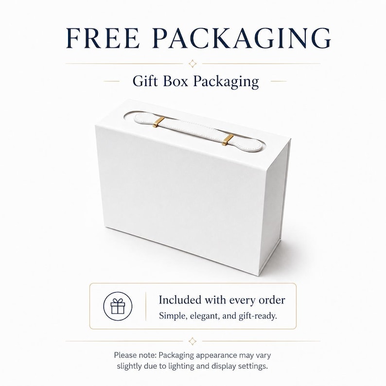 May include: A rectangular white gift box with a top handle featuring gold-colored metal accents. The text reads FREE PACKAGING, Gift Box Packaging, and Included with every order. Simple, elegant, and gift-ready. Please note: Packaging appearance may vary slightly due to lighting and display settings.