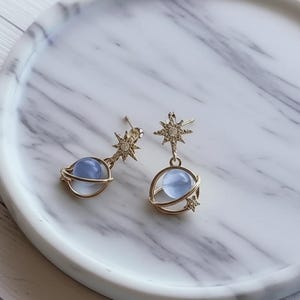 Gold Saturn Dangle Earrings with Blue Stones and Celestial Star and Planet