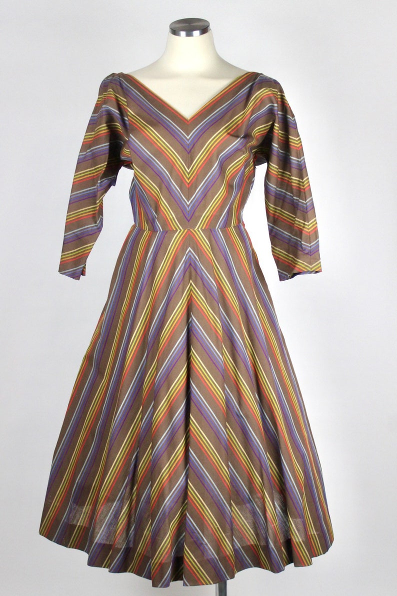 Vintage 1950s full swing dress with rainbow stripes in chevron style pattern dolman sleeve