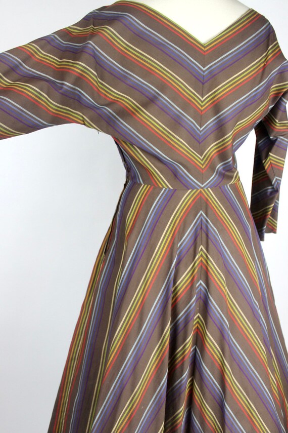 Vintage 1950s full swing dress with rainbow stripes in chevron style pattern dolman sleeve