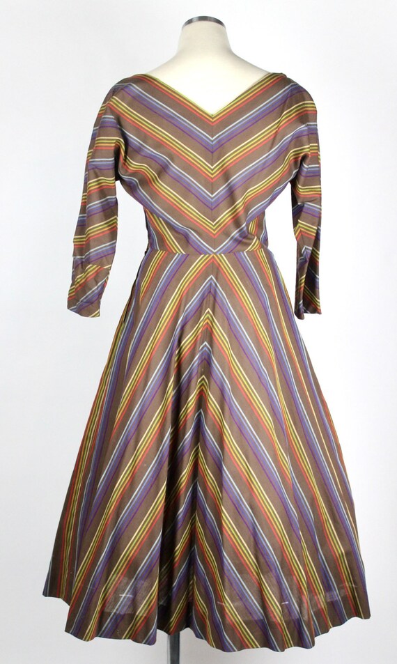 Vintage 1950s full swing dress with rainbow stripes in chevron style pattern dolman sleeve