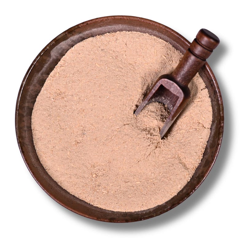 May include: Overhead shot of a round, brown bowl filled with light brown powder. A small, dark wooden scoop rests in the powder. The bowl has a dark rim and sits on a white background.