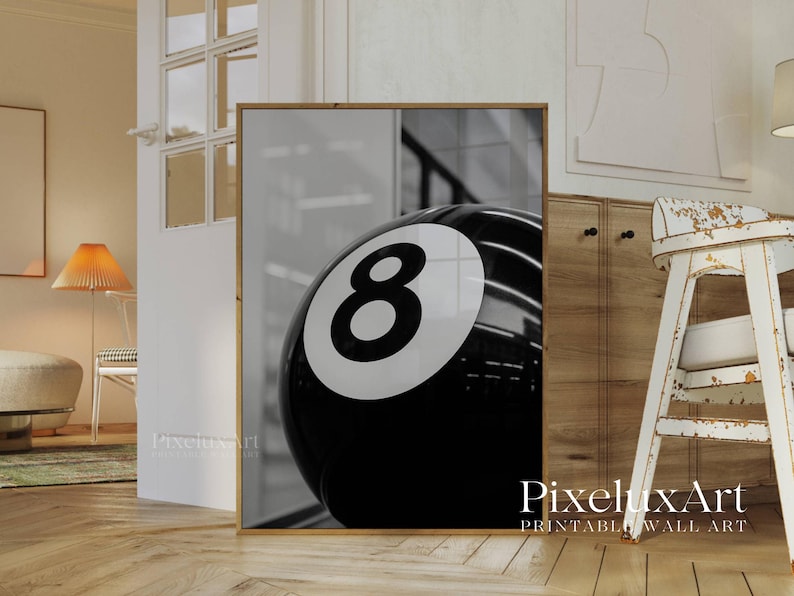 May include: Black and white framed print featuring a close-up of a glossy eight ball. The number eight is prominently displayed in white against the black surface of the ball. The print is a modern wall art piece.