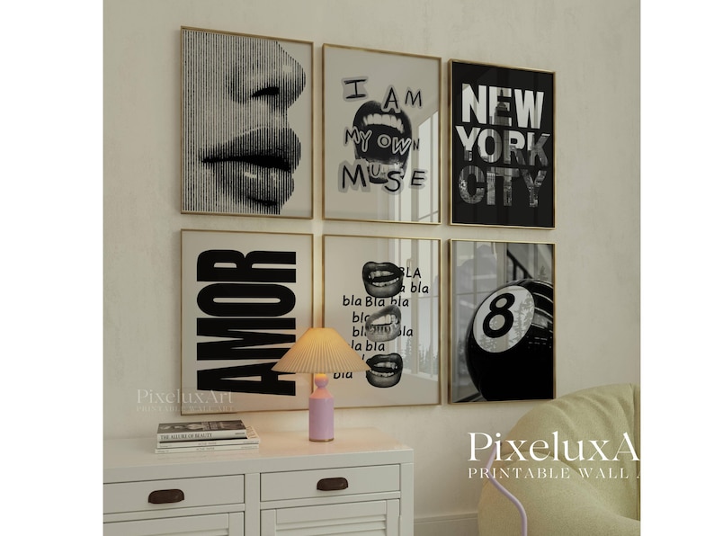 May include: A collection of six framed art prints with gold frames. The prints feature black and white graphics, including a close-up of lips, the words "I AM MY OWN MUSE", "NEW YORK CITY", "AMOR", and a pool ball with the number 8.