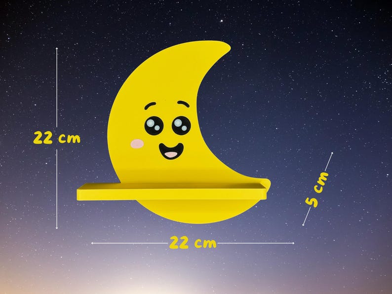 May include: A yellow crescent moon-shaped shelf with a smiling face, measuring 22 cm wide and high, and 5 cm deep. The shelf is set against a starry night sky background. A decorative item for a child's room.