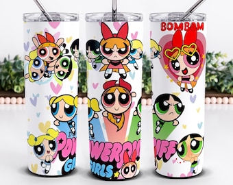 May include: Three white stainless steel tumblers featuring the Powerpuff Girls cartoon characters. Each tumbler has a different design, with the characters in various poses and the words "Powerpuff Girls" and "Bombam" in bold, colorful fonts. The tumblers have a silver straw.