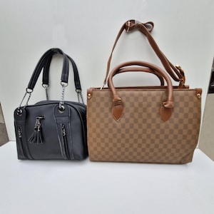 May include: Two handbags. One is black with silver chain straps, a tassel, and zipper details. The other is brown with a checkered pattern, brown handles, and a detachable shoulder strap.
