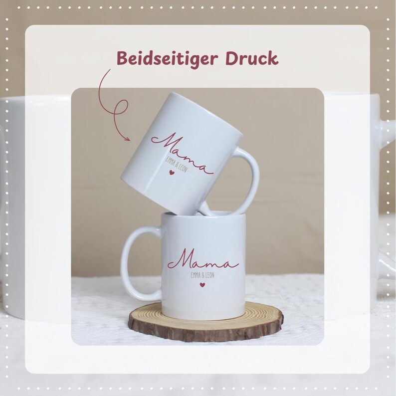 May include: Two white ceramic mugs stacked on a wooden coaster. Each mug has a handle and features the word "Mama" in a cursive font, along with a small heart and the names "Emma & Leon". The text "Beidseitiger Druck" is at the top.