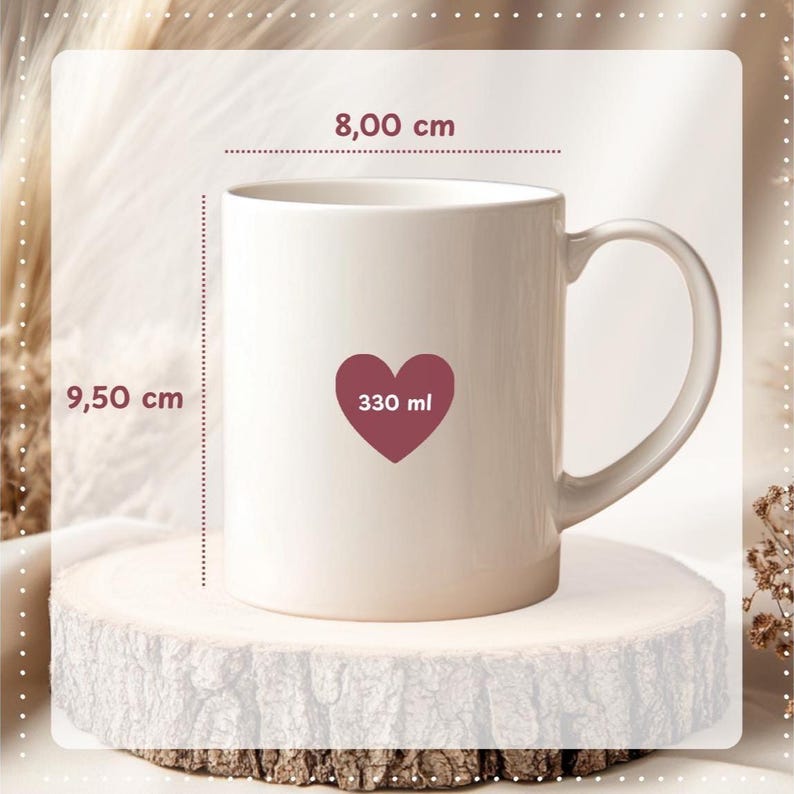 May include: A cream-colored ceramic mug with a heart-shaped design containing the text "330 ml". The mug is 3.74 inches tall and 3.15 inches wide. The mug has a curved handle and is displayed on a wooden surface.