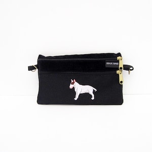 May include: Black zippered pouch with a white embroidered bull terrier design and the text "Dixie Bags" on the front.