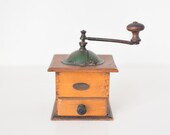 Vintage wood and tin coffee grinder with green lid