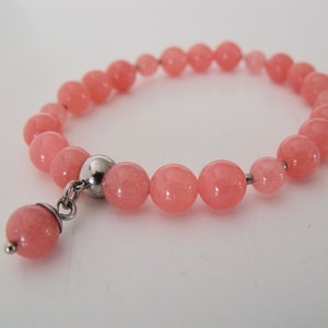Beaded pink quartz stretch bracelet with stainless steel quartz dangle