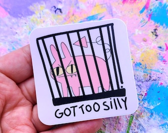 May include: A square sticker featuring a pink cartoon creature inside a black and white cage. The creature has yellow eyes and a tail. The text "GOT TOO SILLY" is printed in black at the bottom of the sticker.