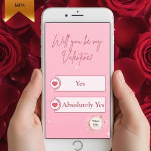 May include: A smartphone displays a pink Valentine's Day graphic with the text "Will you be my Valentine?" and two response options: "Yes" and "Absolutely Yes." The phone is held against a backdrop of red roses, with a gold digital download banner.