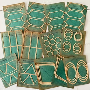 May include: A collection of vintage embroidery patterns on aged green cards. The cards feature various geometric designs and shapes, including circles, squares, and lines, all crafted with natural-colored thread. The text "MONOGRAMME à broder" is visible on some cards.