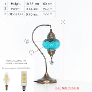 May include: A decorative table lamp with a turquoise glass globe, measuring 19.68 inches (50 cm) in height and 6.70 inches (17 cm) in diameter. The lamp has a bronze-colored metal base and a curved arm. The text "BULB NOT INCULED" is visible.