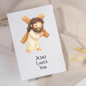 Puede incluir: Una tarjeta de felicitaci&oacute;n blanca con una ilustraci&oacute;n en acuarela de una figura con cabello casta&ntilde;o y barba, vistiendo una t&uacute;nica color crema y una corona de espinas, cargando una cruz de madera. El texto "Jesus Loves You" est&aacute; impreso en negro.