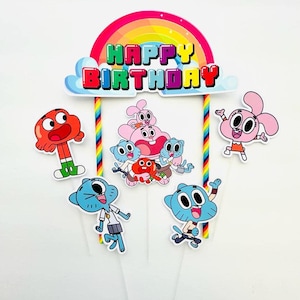 May include: A colorful birthday cake topper featuring cartoon characters and the words "HAPPY BIRTHDAY" in bright letters. The topper includes a rainbow, clouds, and several character cutouts on clear sticks.