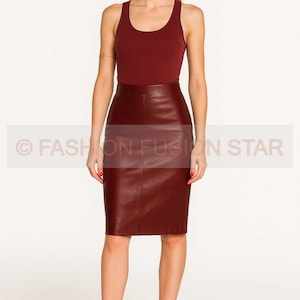 May include: A burgundy tank top paired with a burgundy leather pencil skirt. The skirt is knee-length and has a fitted silhouette. The image includes the text "© FASHION FUSION STAR".