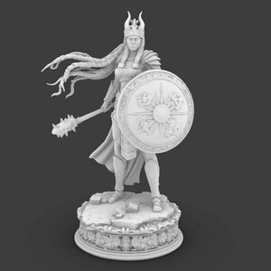 May include: A white figurine of a warrior woman, holding a mace and shield. The shield features a sunburst design. The figure is adorned with a crown and armor, standing on a detailed base. The statue is approximately 25 cm tall.