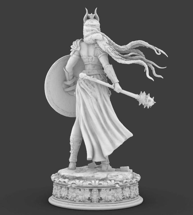 May include: A white statue of a warrior figure, seen from behind, holding a shield and a mace. The figure wears armour, a flowing cape, and a horned helmet. The statue stands on a decorative base with floral patterns.