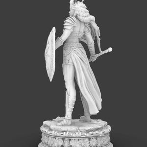 May include: A grayscale figurine of a warrior woman, seen from behind. She is clad in armour, a helmet, and a flowing skirt, holding a shield and sword. The figure stands on a decorative base with floral patterns, against a dark backdrop.