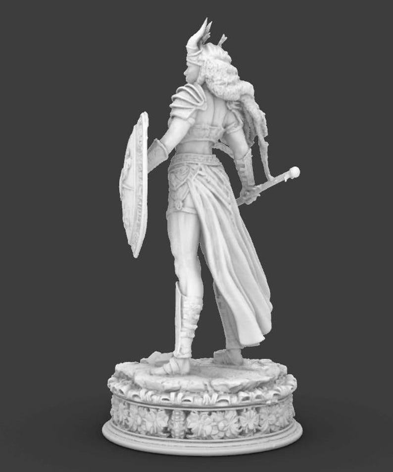 May include: A grayscale figurine of a warrior woman, seen from behind. She is clad in armour, a helmet, and a flowing skirt, holding a shield and sword. The figure stands on a decorative base with floral patterns, against a dark backdrop.