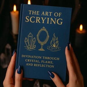 May include: A dark blue book titled "THE ART OF SCRYING" with gold lettering and illustrations of crystals, a mirror, and a flame. The subtitle reads "DIVINATION THROUGH CRYSTAL, FLAME, AND REFLECTION".