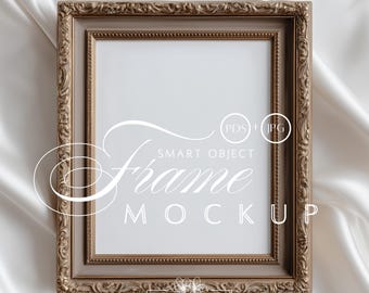 May include: A rectangular, ornate, gold-toned picture frame mockup with a white interior. The frame has detailed carvings and is set against a white, silky background. The text "Frame Mockup" is visible on the frame.