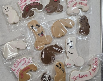 May include: A collection of penis-shaped cookies in various colors, individually wrapped in clear plastic. Some cookies have faces, while others have text that reads "Wishing you much HAP-PENIS" and "To have & to hold".