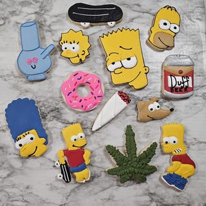 May include: A collection of decorated sugar cookies in various shapes and designs. The cookies include cartoon characters, a donut, a marijuana leaf, a bong, a skateboard, a beer can, and a rolled cigarette.