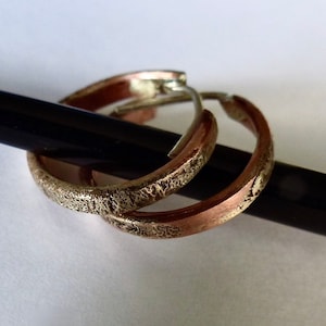 Men&#39;s copper and silver unique hoops earrings.
