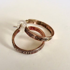 Men&#39;s copper and silver unique hoops earrings.